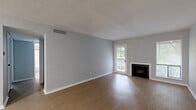 Located at 5600 E 84th Terrace in Kansas City, Missouri, this 2-bedroom, 1-bathroom single-story residence offers a functional and well-organized layout. The open living room is a standout space, featuring light wood-style flooring, neutral gray walls, a classic fireplace, and windows that invite natural light and outdoor views. A ceiling fan adds comfort to the adjoining area that flows toward the kitchen.

The kitchen is equipped with white cabinetry featuring black hardware, light speckled countertops, a black faucet with a single basin sink, and stainless steel appliances including a full-size refrigerator and range. An in-unit washer and dryer are conveniently tucked behind a closet door near the kitchen area.

Both bedrooms are carpeted and offer a quiet, comfortable atmosphere. The primary bedroom is a well-proportioned space with large sliding closet doors and a window allowing natural light. The second bedroom features its own closet and similarly neutral finishes throughout.

The bathroom is clean and straightforward, with a full tub-shower combination with white tile surround, wood-style flooring, and a textured wall finish. Throughout the residence, consistent neutral tones and light flooring create a cohesive, move-in-ready environment.