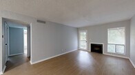 Located at 5600 E 84th Terrace in Kansas City, Missouri, this 2-bedroom, 1-bathroom single-story residence offers a functional and well-organized layout. The open living room is a standout space, featuring light wood-style flooring, neutral gray walls, a classic fireplace, and windows that invite natural light and outdoor views. A ceiling fan adds comfort to the adjoining area that flows toward the kitchen.

The kitchen is equipped with white cabinetry featuring black hardware, light speckled countertops, a black faucet with a single basin sink, and stainless steel appliances including a full-size refrigerator and range. An in-unit washer and dryer are conveniently tucked behind a closet door near the kitchen area.

Both bedrooms are carpeted and offer a quiet, comfortable atmosphere. The primary bedroom is a well-proportioned space with large sliding closet doors and a window allowing natural light. The second bedroom features its own closet and similarly neutral finishes throughout.

The bathroom is clean and straightforward, with a full tub-shower combination with white tile surround, wood-style flooring, and a textured wall finish. Throughout the residence, consistent neutral tones and light flooring create a cohesive, move-in-ready environment.