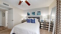 Located at 501 Rosery Rd NE in Largo, Florida, this single-story home offers a well-organized floor plan designed for comfortable everyday living. The living room serves as the heart of the home, featuring wood-look flooring, a ceiling fan, and a sliding glass door that fills the space with natural light and provides access to an outdoor area. A built-in electric fireplace anchors the room, adding warmth and a focal point for the seating area.

The galley-style kitchen is efficiently laid out with warm wood cabinetry lining both walls, dark granite-style countertops, white appliances, and a window above the sink that lets in additional natural light. The layout maximizes storage and counter space throughout.

The bedrooms are generously proportioned, with the primary bedroom offering plush carpeting, a ceiling fan, and a large window dressed with sheer curtains that allow soft, diffused light. The second bedroom mirrors a similar cozy aesthetic with carpet flooring and a ceiling fan overhead.

The bathroom features wood-look flooring, a shower-tub combination, and clean, neutral finishes. A hallway connects the main living areas and includes a louvered closet door, providing convenient storage access. In-unit laundry with a full-size washer and dryer and overhead shelving completes this practical and comfortable home.