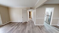 Located at 1505 Greenbrier Ridge Way in Knoxville, TN, this single-story, 1-bedroom, 2-bathroom home offers a well-designed layout with thoughtful finishes throughout. Wood-look plank flooring runs through the main living areas, complemented by neutral warm-beige walls and crisp white trim with crown molding details visible in the living room and hallway.

The living room is bright and welcoming, featuring crown molding and a front entry door alongside a glass-paneled door that floods the space with natural light and provides outdoor access. The adjacent dining area connects seamlessly to the galley-style kitchen, which is a standout feature of the home. The kitchen is equipped with white shaker cabinetry, granite countertops, stainless steel appliances, and a skylight overhead that enhances natural illumination.

The spacious bedroom is carpeted for comfort, includes a ceiling fan with lighting, and features two windows that offer outdoor views and ample natural light. Both bathrooms are finished with granite-topped vanities, white cabinetry, and tiled tub-shower combinations. A dedicated closet provides organized storage, and a connecting hallway ties all rooms together efficiently. This home presents a clean, modern aesthetic throughout.