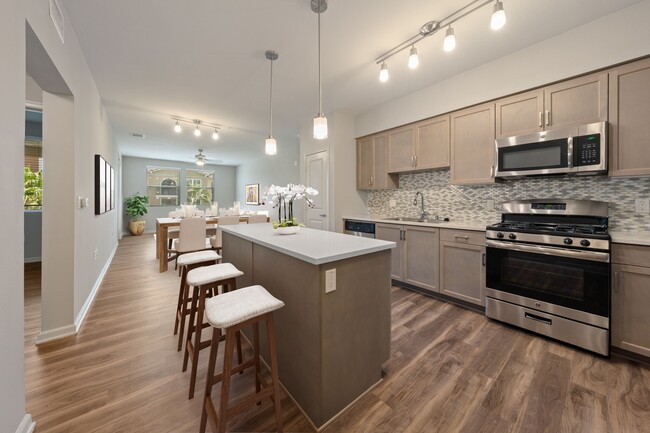 Kitchens are complete with quartz countertops and custom tile backsplash. - Valentia by Windsor