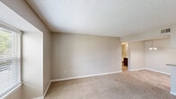 Located at 1712 India Hook Rd in Rock Hill, SC, this single-floor, 3-bedroom, 1-bathroom home offers a practical and well-appointed layout. The kitchen is a standout feature, boasting dark gray shaker-style cabinetry, granite countertops, stainless steel appliances including a refrigerator and electric range, a double basin sink, and light wood-style flooring — all illuminated by overhead lighting. The living room provides a welcoming entry point with carpet flooring, neutral taupe walls, a textured ceiling, and a window that allows natural light to flow in. Each of the three bedrooms is finished with plush carpet, neutral-toned walls, and ceiling fans with light fixtures. The primary bedroom includes a walk-in closet with wire shelving, while additional bedrooms feature either walk-in or bifold-door closets with outdoor-facing windows. The full bathroom is equipped with a tub-shower combination and chrome fixtures. A connecting hallway ties the rooms together efficiently. Throughout the home, consistent use of neutral tones, textured ceilings, and carpet in living areas creates a cohesive and comfortable atmosphere.