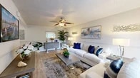 Located at 4500 Baymeadows Rd in Jacksonville, FL, this single-story, 3-bedroom, 2-bathroom home offers a smartly designed layout that maximizes every inch of its space. The living room serves as the heart of the home, featuring warm wood-look flooring, a ceiling fan with light fixture, a textured ceiling, and a large sliding glass door that floods the room with natural light and provides outdoor access. Chair-rail molding adds a refined architectural detail to the neutral-toned walls.

The galley-style kitchen is both stylish and functional, showcasing white cabinetry, granite-look countertops, stainless steel appliances including a refrigerator and range, and a skylight that brings in additional natural light. The space is efficient and well-organized.

The primary bedroom is a comfortable retreat with plush carpeting, a ceiling fan, and a window allowing natural light. A dedicated closet with open shelving provides convenient storage. The additional bedrooms share similar finishes and feature carpet flooring.

Both bathrooms are clean and well-appointed, with granite-look vanity tops, tiled tub-shower combinations, and wood-look flooring. A hallway connects the bedrooms and living areas seamlessly, completing this cohesive and move-in-ready home.