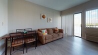 Located at 280 Sierra Dr in Miami, FL, this two-bedroom, one-bathroom unit offers a cheerful coastal aesthetic carried throughout its single-floor layout. The open-concept living and dining area serves as the heart of the home, featuring light wood-style flooring, a comfortable sofa, and a dining set positioned near a sliding glass door fitted with vertical blinds that invite natural light and provide access to an outdoor area. Vibrant marine-themed artwork decorates the walls, reinforcing the playful seaside atmosphere found in every room. The kitchen is efficiently laid out with dark cabinetry, ample counter space, and full-size appliances. The primary bedroom accommodates a full-size sleigh bed with dark wood framing and benefits from a window with outdoor views. The second bedroom is configured with two twin sleigh beds, also in dark wood, and features its own window with natural light and exterior views. The shared full bathroom is finished with light tile flooring, a dark vanity with an integrated sink and mirror cabinet, and a shower-tub combination. Colorful fish-themed artwork adds a fun, cohesive touch to the bathroom as well. The unit's consistent coastal décor and practical layout make it a well-organized and inviting Miami residence.