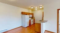 This 2-bedroom, 2-bathroom residence at 5317 Palouse Hwy in Spokane, Washington offers a well-organized single-floor layout with a clean, functional design throughout. Warm hardwood-style flooring flows through the main living areas and kitchen, creating a cohesive and easy-to-maintain interior.

The kitchen is equipped with warm wood cabinetry, tile backsplash, laminate countertops, and a full suite of white appliances including a refrigerator, electric range, microwave, and dishwasher. A peninsula with additional counter space opens toward the living area, making the kitchen both practical and accessible. Ceiling-mounted light fixtures provide consistent illumination throughout.

The open living area features large windows that invite natural light and offer views of the surrounding Spokane landscape. Soft carpeting in the living and sleeping areas adds comfort underfoot. A dedicated in-unit laundry area with a washer and dryer adds notable convenience.

Both bedrooms are carpeted and receive natural light through generously sized windows with outdoor views. The primary bedroom offers comfortable proportions with dedicated closet storage. Two full bathrooms each include a tub/shower combination, toilet, and wood-trimmed vanity with a countertop sink — one with tile flooring and one with hardwood-style flooring. Two closets provide ample storage throughout the residence.