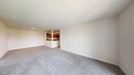 This well-appointed two-bedroom, two-bathroom residence in Carteret, NJ offers a thoughtfully organized single-floor layout designed for comfortable everyday living. A welcoming hallway connects the main living areas, with plush carpeting running throughout the bedrooms and living spaces, while the kitchen features durable wood-look flooring. The open-concept living and dining area is bright and generously proportioned, flowing seamlessly into a semi-open kitchen outfitted with rich dark wood cabinetry, granite countertops, a tile backsplash, and stainless steel appliances including a refrigerator, dishwasher, and range. The spacious primary bedroom offers ample room and access to a well-sized walk-in closet with wire shelving for organized storage. The second bedroom is bright and versatile. Both bathrooms are clean and functional, with one featuring a tub and shower combination with a sliding glass enclosure and tile surround. A dedicated in-unit laundry room houses a full-size washer and dryer. Additional storage is provided by two closets throughout the unit. A utility room rounds out the floor plan, adding further practical convenience to this well-equipped residence.