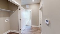 Located at 2712 Country Club Dr in Tallahassee, FL, this single-story, 3-bedroom, 2-bathroom home offers a thoughtfully designed open floor plan. The combined kitchen and living area serves as the heart of the home, featuring light wood-tone luxury vinyl plank flooring, recessed lighting, and ceiling fans. The kitchen is well-appointed with dark gray cabinetry, a central island with a light countertop and undermount sink, black appliances including a refrigerator, range, and microwave, and ample cabinet storage throughout.

The living and dining areas benefit from large windows with horizontal blinds, allowing generous natural light and outdoor views. The primary bedroom is a comfortable retreat with carpet flooring, a ceiling fan, and access to a walk-in closet outfitted with wire shelving. The additional bedrooms also feature plush carpeting, closets, and neutral warm-toned walls. The bathrooms include a tub-shower combination with clean white subway tile surround and chrome fixtures. A dedicated laundry room with wire shelving and washer/dryer hookups adds everyday convenience. The hallways are finished with smooth LVP flooring and clean white trim, tying the entire home together with a cohesive, move-in-ready aesthetic.