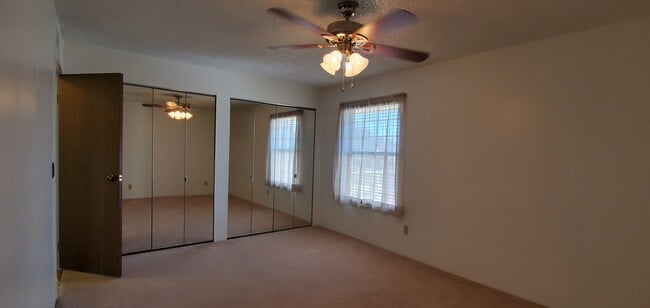 Master bedroom with two full size closets with mirrored doors. - 10251 W 44th Ave