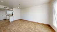 Located at 200 Valencia Dr SE in Albuquerque, NM, this 1-bedroom, 2-bathroom unit offers a practical and well-designed layout across a single floor. Wood-style flooring runs throughout, complemented by clean white walls and warm natural light that streams in through multiple windows fitted with vertical blinds.

The kitchen is a functional galley-style space featuring white shaker cabinetry, granite-look countertops, black appliances including an electric range and refrigerator, and a skylight overhead that fills the room with natural brightness. The kitchen opens seamlessly toward the combined dining and living area, creating a connected, efficient flow.

The living and dining space is open and versatile, providing ample room for multiple furniture arrangements. The bedroom is a comfortable, well-proportioned room with a large window that admits generous natural light and offers outdoor views.

Two bathrooms serve the unit, with one featuring white cabinetry, granite-look countertops, a walk-in shower, and matching wood-style flooring. Two closets provide solid storage options, while a dedicated laundry area adds everyday convenience. A private balcony extends the living space outdoors. The overall ambiance is clean, bright, and move-in ready.