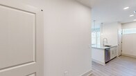 Located at 2145 Robin Lark Dr in Winston Salem, NC, this well-appointed one-bedroom, one-bathroom residence offers a thoughtfully designed single-level layout with modern finishes throughout. The open-concept kitchen and living area serves as the heart of the home, where a granite-topped island with pendant lighting creates a striking focal point. The kitchen is equipped with stainless steel appliances, white shaker-style cabinetry, granite countertops, and a tile backsplash, combining both style and functionality. Light wood-look flooring flows through the main living areas, complementing the crisp white walls and clean aesthetic. The living area is bright and airy, featuring a ceiling fan, multiple windows, and a set of glass French doors that open to an outdoor space, allowing natural light to pour in and providing outdoor views. The bedroom is a comfortable retreat finished with soft carpeting, a ceiling fan, and a large window that frames views of the surrounding area. A dedicated closet provides convenient storage. The bathroom is elegantly finished with a granite-topped white vanity, a large framed mirror, and wood-look flooring. A hallway connects the rooms, ensuring a practical and cohesive flow throughout this modern Winston Salem residence.