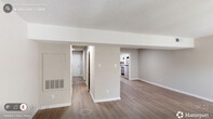 Located at 2029 Bedford Street in Durham, NC, this two-story home offers a practical and well-organized layout spread across two floors. The main level features a welcoming living room filled with natural light from window blinds, showcasing light hardwood-style flooring and a neutral color palette that carries throughout the home. The kitchen is a functional highlight, equipped with white shaker-style cabinetry, granite countertops, stainless steel appliances including a range and refrigerator, a built-in dishwasher, and a skylight that brightens the space. A pantry and hallway complete the main floor, along with carpeted staircase access to the upper level. Upstairs, three bedrooms provide comfortable living quarters, each featuring plush carpet flooring and ceiling fans with light fixtures. The spacious primary bedroom includes an en-suite vanity area with white cabinetry and a granite-topped sink. The home's five bathrooms are clean and functional, featuring tub-shower combinations with tiled surrounds. Eight closets distributed throughout the home ensure exceptional storage capacity. The consistent warm-toned walls, clean white trim, and hardwood-style flooring on the main level create a cohesive and inviting atmosphere throughout this Durham residence.