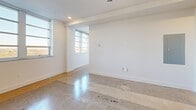 Located at 231 E 25th St in Little Rock, AR, this thoughtfully designed single-floor residence offers a modern aesthetic with a clean, open layout. Polished concrete floors run throughout the entire space, providing a sleek, industrial-chic foundation that reflects natural light beautifully.

The open-concept living, dining, and kitchen area forms the heart of the home. The kitchen is a standout feature, boasting light wood cabinetry, a striking vibrant green tile backsplash, stainless steel appliances including a French door refrigerator and range with overhead ventilation hood, and a central island with a quartz countertop. The living and dining areas are bright and airy, lined with large multi-pane windows that flood the space with natural light, while a ceiling fan adds comfort overhead. A bold yellow accent wall adds a dynamic pop of color to the living area.

The spacious primary bedroom offers generous proportions, with two closets providing ample storage. The full bathroom features a soaking tub and shower combination with large-format tile surround, a wood-toned vanity with matte black hardware, and polished concrete flooring. Additional practical spaces include a dedicated laundry room and utility room, completing this well-appointed and stylish residence.