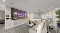 This thoughtfully designed single-floor space combines functionality with contemporary style, making it an ideal venue for gathering and entertaining. The entrance features sleek floor-to-ceiling glass doors that offer a welcoming view into the interior, with lush potted plants framing the entryway and patterned carpet flooring running throughout.

The lounge area is centered around a generous sectional sofa in neutral tones, accented with lime green and white decorative pillows. A textured stone feature wall serves as a striking backdrop for the wall-mounted flat-screen television, flanked by elegant sconce lighting. A sculptural metallic coffee table and a glass-top console table complete the seating area, while sheer vertical drapes filter soft natural light from large windows.

Adjacent to the lounge, a formal dining area accommodates a large rectangular table surrounded by upholstered cream chairs with nailhead trim, illuminated by a dramatic branching chandelier. A second, more intimate conference-style dining arrangement nearby features its own statement pendant lighting and wall-mounted display screen, ideal for presentations or private meetings.

The kitchen is outfitted with stainless steel appliances, dark wood cabinetry, large-format tile flooring, and a spacious quartz island with bar seating. Bold chartreuse accent walls and sculptural pendant lights add a vibrant, modern energy to the culinary space.