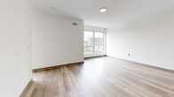 Located at 2132 Stokes Blvd in Cleveland's University Circle neighborhood, this thoughtfully designed one-bedroom, one-bathroom residence offers a clean, contemporary aesthetic throughout. Light-toned luxury vinyl plank flooring flows seamlessly across the entire unit, complementing the bright white walls and creating a cohesive, modern feel.

The open-concept kitchen and living area serves as the heart of the unit. The kitchen is outfitted with two-tone gray cabinetry featuring sleek black hardware, white quartz countertops, a white subway tile backsplash, and stainless steel appliances including a refrigerator, dishwasher, and over-the-range microwave with a built-in cooktop. The adjoining living area is bathed in natural light from a large floor-to-ceiling window offering open city views.

The bedroom is a composed, quiet space with its own oversized window framing urban Cleveland scenery, providing ample natural light. Two closets offer generous storage throughout the unit, and a dedicated laundry area adds everyday convenience.

The bathroom features a clean, minimalist design with gray vanity cabinetry, a white countertop, a large mirror, and accessible grab bars. The space maintains the same light flooring found throughout, tying the design together cohesively.