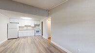 Located at 2909 Burroughs Dr in Pine Hills, FL, this single-floor unit has been thoughtfully updated with modern finishes throughout. Light-toned luxury vinyl plank flooring runs continuously across all areas, creating a cohesive and easy-to-maintain living environment.

The open living area is bright and welcoming, featuring a window that allows natural light to fill the space, along with a wall-mounted HVAC unit for year-round climate control. The layout flows directly into the kitchen, which is outfitted with white shaker-style cabinetry, granite-look countertops, an under-cabinet range hood, and white appliances including a refrigerator and electric range. A single-basin sink with a modern faucet completes the functional workspace.

The bedroom is a well-proportioned, quiet retreat with a textured ceiling, crown molding details, and a closet with sliding doors. The full bathroom features a white vanity with granite-look countertops, a toilet, and a tub-shower combination adorned with elegant marble-style tile surround, adding a refined touch to the space.

A dedicated laundry room houses a full-size washer and dryer along with a water heater, offering practical, all-in-one convenience. Neutral gray walls and clean white trim throughout the unit contribute to a fresh, move-in ready atmosphere.