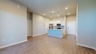 Located at 600 E North Grove Blvd in Waxahachie, TX, this well-designed one-bedroom, one-bathroom residence offers a thoughtfully organized single-floor layout. The open-concept living and kitchen area serves as the heart of the home, featuring warm wood-look flooring, neutral-toned walls, and recessed lighting that creates a bright, welcoming atmosphere. A central kitchen island with a granite countertop and undermount sink anchors the space, illuminated by a trio of pendant lights. White shaker-style cabinetry lines the kitchen walls, complemented by a mosaic tile backsplash, stainless steel appliances including a refrigerator, range, microwave, and dishwasher, and a convenient built-in desk area. A pantry and in-unit stacked washer and dryer add practical functionality. The living area benefits from natural light through large windows with views of the outdoors. The generously sized bedroom is a calm, airy retreat with a large window, while two closets provide ample storage. The bathroom features a wide granite-topped vanity with white cabinetry, a framed mirror, and wood-look flooring, maintaining the consistent, modern aesthetic found throughout the home.