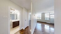 Located on the 14th floor at 155 Wellesley St E in Toronto's vibrant Church-Wellesley Village, this one-bedroom, one-bathroom unit offers a well-organized layout across a single floor. Rich parquet hardwood flooring runs throughout the main living areas and bedroom, adding warmth and a classic character to the space.

The kitchen is fitted with dark espresso cabinetry, stainless steel appliances including a refrigerator and dishwasher, a tile backsplash, and neutral floor tiles — providing a functional and modern cooking area. The living area flows naturally from the kitchen, offering an open and airy feel with neutral grey walls.

The bedroom is a comfortable, private retreat featuring the same parquet flooring, a built-in double closet for storage, and a large window that frames sweeping city skyline views, allowing ample natural light to fill the room. A baseboard heating unit ensures year-round comfort.

The bathroom is finished with clean white subway tile surrounding a full soaker tub and shower combination, lending a bright and timeless aesthetic. The unit also includes access to a private balcony, ideal for enjoying outdoor views of the Toronto skyline. This unit combines classic design elements with modern finishes in a sought-after downtown location.