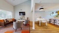 Located at 11330 Colorado Ave in Kansas City, MO, this thoughtfully designed single-floor space offers an open-concept layout that seamlessly connects the living room, dining area, and kitchen. The living room is a standout feature, boasting soaring vaulted ceilings that amplify the sense of space and large sliding glass doors that flood the room with natural light and provide outdoor views. Warm hardwood flooring flows consistently throughout the entire space, creating a cohesive and inviting atmosphere. The kitchen is both functional and visually striking, featuring bold golden-yellow accent walls that contrast beautifully with crisp white cabinetry, light quartz countertops, a classic subway tile backsplash, and a full suite of stainless steel appliances including a gas range, microwave, dishwasher, and French door refrigerator. A white breakfast bar with pendant lighting bridges the kitchen and dining area, offering additional seating alongside the dedicated dining space. The dining area is defined by soft, light gray walls and modern overhead lighting, creating a calm and comfortable setting. Structural columns add architectural character to the open floor plan while maintaining a clear sense of visual flow throughout the home.
