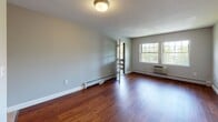 Located at 216 Olde Derby Rd in Norwood, MA, this single-floor residence offers a thoughtfully laid-out living space with a neutral color palette and a variety of modern finishes throughout. The open living area features rich hardwood flooring and multiple windows that invite an abundance of natural light, with views of surrounding greenery. Baseboard heating and a wall-mounted air conditioning unit ensure year-round comfort. The kitchen is well-equipped with warm wooden cabinetry, granite countertops, a stainless steel refrigerator, dishwasher, and a gas range, offering both style and functionality. The bedrooms are carpeted for comfort, each featuring windows with outdoor views and baseboard heating; one bedroom includes a closet with bifold doors. The bathrooms are clean and functional — one features a white vanity with a tub-shower combination with tiled walls, while the second offers a neo-angle glass-enclosed shower with decorative tile accents, a white vanity, and tile flooring. A dedicated entryway connects the main living space to the kitchen, completing this well-organized and move-in ready home in a convenient Norwood location.
