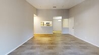 Located in Brookhaven, GA, this one-bedroom, one-bathroom residence offers a well-designed single-floor layout with a neutral color palette and wood-style flooring throughout the main living areas. The living room is a standout space, featuring soaring ceilings, a tile-surround fireplace, and a sliding glass door that fills the room with natural light and provides access to an outdoor balcony. The galley-style kitchen is outfitted with white cabinetry, light stone countertops, a double-basin stainless steel sink, and a full suite of stainless steel appliances including a refrigerator, range, microwave, and dishwasher. A pendant light fixture adds a finished touch overhead. The bedroom is generously sized with plush wall-to-wall carpeting and direct access to a large walk-in closet equipped with multiple shelving rods for ample storage. The full bathroom features a tiled shower-tub combination, a single-sink vanity with white cabinetry and stone countertop, and wood-look tile flooring. A dedicated laundry area houses a full-size Whirlpool washer and dryer, complemented by an additional storage room with built-in shelving, offering exceptional organizational capacity for a residence of this size.