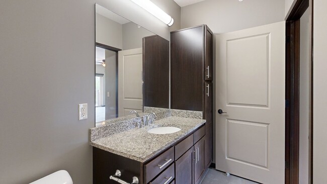 We offer plenty of storage and vanity space in our bathrooms. - Villas of Omaha at Butler Ridge