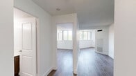 Located at 295 Dufferin Street, Suite 503, in Toronto's vibrant King West neighbourhood, this three-bedroom, one-bathroom unit offers a well-designed single-floor layout with a clean, modern aesthetic throughout. The open living area features light hardwood-style flooring, crisp white walls, and a textured ceiling, creating a bright and airy atmosphere. Large windows in the living space allow generous natural light and offer pleasant views of the surrounding greenery. A structural column subtly defines the transition between the living and dining areas without disrupting the open feel of the space. The kitchen is fully updated with white shaker-style cabinetry, dark countertops, a grey subway tile backsplash, polished tile flooring, and a complete suite of stainless steel appliances including a refrigerator, dishwasher, microwave, and electric range. The three bedrooms are each finished with hardwood-style flooring and white walls. The primary bedroom includes mirrored sliding closet doors and a window with outdoor views. The four-piece bathroom is finished with classic white subway tile surrounding a full soaking tub with shower, providing a clean and timeless look. Overall, the unit presents a fresh, functional, and well-maintained living environment.