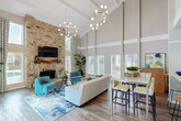 Located on Georgian Drive in Mobile, Alabama, this single-story residence offers a well-organized layout with a range of functional and comfortable features throughout. The living area serves as the focal point of the home, showcasing wood-look laminate flooring, a classic brick fireplace, and a ceiling fan overhead. A sliding glass door floods the space with natural light and provides direct access to a private patio. The galley-style kitchen is efficiently designed with ample white cabinetry, dark granite-style countertops, black appliances including an electric range, microwave, and refrigerator, and a double stainless steel sink. A pendant light fixture adds a refined touch at the kitchen's end, which opens toward a dining or entry area. The bedrooms are carpeted for comfort, each equipped with ceiling fans and windows with blinds that allow natural light while maintaining privacy. The primary bedroom features two separate doorways leading to a walk-in closet with built-in shelving and a private en-suite bathroom. The bathroom is appointed with white cabinetry, a dark countertop vanity, a large mirror, and clean, neutral finishes. Textured ceilings are consistent throughout the home, contributing to the overall classic aesthetic of this practical and inviting residence.