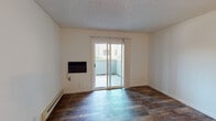Located at 1640 Ambergrove Dr in San Jose, California, this single-floor unit offers a practical and well-organized layout. The living area is finished with rich, dark wood-style flooring and features a wall-mounted heater, a baseboard heating unit, and a sliding glass door that opens to a private patio, allowing natural light to filter into the space and providing a direct outdoor connection.

The kitchen is laid out in a galley-style configuration, featuring white cabinetry with ample storage, light-toned laminate countertops, a stainless steel refrigerator, a gas range, a dishwasher, and a sink. Light wood-style flooring runs throughout the kitchen, contributing to a clean and cohesive aesthetic. A partial wall separates the kitchen from the main living area, maintaining an open feel while defining each functional zone.

The bedroom is carpeted and finished with neutral tones, offering a quiet and comfortable retreat. A sliding mirrored closet provides convenient storage. The bathroom includes a shower-tub combination, a toilet, a vanity with storage, and wood-style flooring, all finished in a clean, white palette. A textured ceiling is consistent throughout the unit.