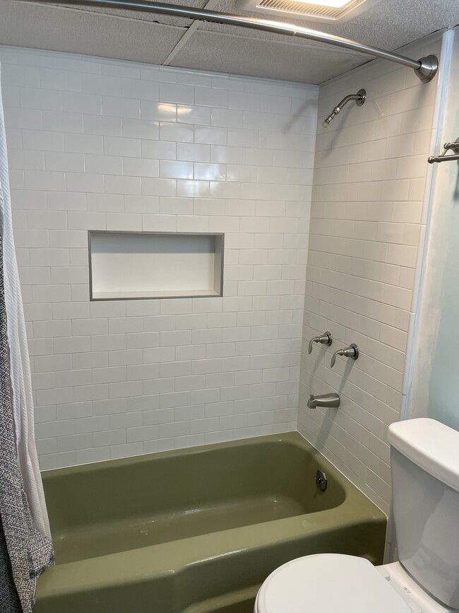 New white subway tile around tub. Built in niche for shampoo, etc. - 2323 Crestmont Ave