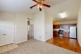 Located at 14001 Three Rivers Rd in Gulfport, Mississippi, this single-floor, 2-bedroom, 2-bathroom home offers a well-organized and functional layout. The living room is a standout space, featuring soaring vaulted ceilings and a ceiling fan with light kit, creating an open and airy atmosphere. Neutral carpet flows through the living areas and bedrooms, while warm hardwood-style flooring defines the kitchen and dining areas.

The combined kitchen and dining room is equipped with rich medium-toned wood cabinetry, granite-look countertops, and a full suite of stainless steel appliances including a gas range, microwave, refrigerator, and dishwasher. An entrance foyer with tile flooring and double closet doors provides a welcoming transition into the main living space.

Both bedrooms are carpeted and include ceiling fans. The primary bedroom offers a comfortable footprint with closet access. The second bedroom is bright, featuring a window with blinds and a double-door closet. Two full bathrooms serve the home — one with a shower stall and one with a tub/shower combination, both featuring tile flooring and light countertops. Additional highlights include a dedicated laundry area and an impressive seven closets throughout, ensuring ample storage at every turn.