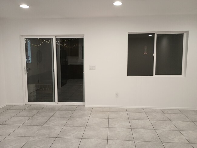 Sliding glass doors to the patio. Nighttime sorry. - 19021 N 45th Dr