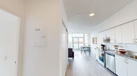 Located at 2 River Plate St in Ajax, Ontario, this well-appointed 3-bedroom, 2-bathroom unit offers a bright and contemporary living experience across a single floor. The open-concept layout seamlessly connects the living, dining, and kitchen areas, all finished with light wood-tone flooring and crisp white walls that enhance the sense of space and airiness throughout.

The living area is a standout feature, with expansive floor-to-ceiling windows that flood the room with natural light and frame impressive views of the surrounding urban skyline. The kitchen is clean and functional, equipped with white cabinetry and stainless steel appliances. A dedicated dining area sits adjacent, offering a natural flow for entertaining.

Each of the three bedrooms is thoughtfully designed with large windows that capture outdoor views, built-in sliding closets, and a calm, neutral palette. The primary bedroom enjoys a particularly striking window outlook over the cityscape.

The two bathrooms are finished in a clean, modern style, each featuring a full bathtub with shower, white tile surrounds, and contemporary fixtures. A connecting hallway with light wood flooring ties all rooms together efficiently. This unit combines functional design with modern aesthetics in a vibrant Ajax community.