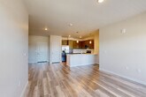 Located at 6415 Templeton Gap Road in Colorado Springs, CO, this well-appointed 2-bedroom, 2-bathroom residence offers a thoughtfully designed single-level floor plan. The open-concept kitchen and living area serves as the heart of the home, featuring sleek dark cabinetry, stainless steel appliances including a refrigerator with ice maker, electric range, and built-in microwave, along with light quartz countertops and a peninsula with pendant lighting — ideal for both everyday living and entertaining. Light-toned luxury vinyl plank flooring runs throughout the main living areas, complementing the neutral wall tones and clean-lined aesthetic. Large windows bathe the living space in natural light and provide views of the surrounding Colorado Springs neighborhood, with a glass door opening to a private balcony. Both bedrooms are carpeted for comfort and offer windows with natural light. The generously sized primary bedroom includes a dedicated walk-in closet with built-in shelving. The two bathrooms are finished with tile-surround soaking tubs, dark cabinetry with brushed nickel hardware, and matching vinyl plank flooring. An additional closet provides further storage flexibility throughout this efficiently designed, move-in-ready residence.