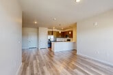 Located at 6415 Templeton Gap Road in Colorado Springs, CO, this well-appointed 2-bedroom, 2-bathroom residence offers a thoughtfully designed single-level floor plan. The open-concept kitchen and living area serves as the heart of the home, featuring sleek dark cabinetry, stainless steel appliances including a refrigerator with ice maker, electric range, and built-in microwave, along with light quartz countertops and a peninsula with pendant lighting — ideal for both everyday living and entertaining. Light-toned luxury vinyl plank flooring runs throughout the main living areas, complementing the neutral wall tones and clean-lined aesthetic. Large windows bathe the living space in natural light and provide views of the surrounding Colorado Springs neighborhood, with a glass door opening to a private balcony. Both bedrooms are carpeted for comfort and offer windows with natural light. The generously sized primary bedroom includes a dedicated walk-in closet with built-in shelving. The two bathrooms are finished with tile-surround soaking tubs, dark cabinetry with brushed nickel hardware, and matching vinyl plank flooring. An additional closet provides further storage flexibility throughout this efficiently designed, move-in-ready residence.