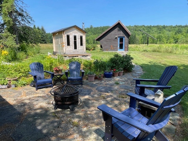 Rear patio with Adirondack chairs - 223 Huntley Rd