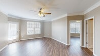 Located at 6720 W 138th Terrace in Overland Park, Kansas, this single-floor residence offers a thoughtfully designed layout with consistent finishes throughout. The living areas feature rich wood-look flooring, neutral taupe walls, and crisp white trim and crown molding, creating a warm yet polished ambiance. Ceiling fans with integrated lighting are present in multiple rooms, and an abundance of windows dressed with white horizontal blinds fills the space with natural light.

The kitchen is outfitted with dark espresso cabinetry, granite countertops, a classic white subway tile backsplash, and a full suite of stainless steel appliances, including a range, over-the-range microwave, and refrigerator. Light tile flooring completes the functional and stylish kitchen space.

The bedrooms are generously sized, each with ceiling fans, ample natural light, and wood-look flooring. One bedroom features a mirrored sliding closet, while another includes a spacious walk-in closet with wire shelving systems for organized storage.

The primary bathroom offers a dual-sink vanity with granite countertops, dark cabinetry, framed mirrors, and a separate walk-in shower. A secondary bathroom features a single vanity with matching granite countertops and a tub-shower combination. Together, the rooms present a cohesive, move-in-ready residence with quality finishes throughout.