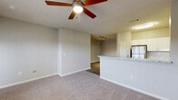 Located at 500 Briarvista Way in Atlanta, GA, this well-appointed one-bedroom, one-bathroom residence offers a thoughtfully designed single-floor layout. The open-concept living, dining, and kitchen area serves as the heart of the home, featuring wood-look flooring, track lighting, and a graceful arched entryway that adds architectural character. Ceiling fans in the living area enhance comfort throughout.

The kitchen is outfitted with crisp white cabinetry, granite-style countertops, stainless steel appliances including a gas range and refrigerator, and a peninsula that provides additional prep space and a natural divider between the kitchen and living areas.

The spacious bedroom benefits from plush carpeting, natural light through large windows with views of the outdoors, a ceiling fan, and an arched passage leading to an expansive walk-in closet with multi-tier wire shelving for ample storage. Four closets in total ensure generous organization throughout the unit.

The bathroom features wood-look flooring, a granite-topped vanity, and a full soaking tub with tiled surround. A dedicated in-unit laundry area accommodates a full-size washer and dryer. A pantry, hallway, and private balcony round out this well-organized and functional residence.