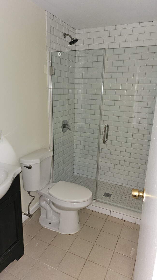 Bathroom features large modern shower - 61 E Main St