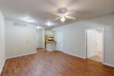 Located at 2000 Pine Crest Ave in Covington, Louisiana, this single-story, 4-bedroom, 2-bathroom home offers a well-designed layout suited for comfortable everyday living. The open-concept main area seamlessly connects the living room, dining room, and kitchen, all unified by warm wood-look hardwood flooring and ceiling fans that promote airflow throughout. The kitchen is efficiently arranged with light maple cabinetry, granite-style countertops, a peninsula with an undermount sink, a dishwasher, and black appliances including a range and refrigerator. A dedicated pantry and an in-unit laundry room with washer and dryer hookups add practical convenience. The four bedrooms feature plush carpeting, ceiling fans, and windows with blinds that allow natural light. The primary bedroom includes its own closet and direct access to one of the two bathrooms, which is equipped with a tub-shower combo, a single vanity with warm-toned cabinetry, and wood-look flooring. Seven closets throughout the home provide generous storage. A patio extends the living space outdoors, offering a private area for relaxation. The home's neutral color palette and clean finishes create a bright, welcoming atmosphere throughout.