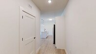 Located at 610 Sugar Pine Way in Wake Forest, NC, this single-story, one-bedroom, one-bathroom home offers a thoughtfully designed layout with modern finishes throughout. The open-concept living and kitchen area serves as the heart of the home, anchored by a large center island with a white quartz countertop and matte black undermount sink. Crisp white shaker cabinetry with black hardware lines the kitchen walls, complemented by a white subway tile backsplash and a full suite of stainless steel appliances, including a French door refrigerator, electric range, built-in microwave, and dishwasher. Stylish pendant lighting with Edison bulbs hangs above the island, adding a contemporary touch. Light wood-look flooring extends through the main living areas, enhancing the bright and airy atmosphere. The living area features a ceiling fan and large windows that invite natural light and outdoor views. The spacious bedroom is carpeted for comfort, includes a ceiling fan, a closet with a rod, and a window with neighborhood views. The bathroom is clean and functional, offering a tub/shower combination, light wood-look flooring, and a bright white palette with matte black accents throughout.