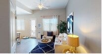 This single-floor residence offers a thoughtfully designed open-concept layout that seamlessly connects the kitchen, dining, and living areas. The kitchen is a standout feature, outfitted with crisp white cabinetry, granite-style countertops, and a full suite of stainless steel appliances including a range, microwave, and dishwasher. A peninsula with bar seating provides a casual dining option and serves as a natural divider between the kitchen and the main living space. The living area is bright and welcoming, featuring wood-style plank flooring, a ceiling fan, and large windows fitted with blinds and curtain panels that allow for ample natural light. A front entry door with a sidelight further enhances the natural brightness of the space. The bedroom offers a cozy retreat, highlighted by a bold navy accent wall, plush carpeting, and generously sized windows. The bathroom is clean and functional, featuring matching granite-style countertops, white cabinetry, wood-style flooring, and a window for natural ventilation. Throughout the residence, neutral wall tones, consistent finishes, and modern fixtures create a cohesive and inviting atmosphere.