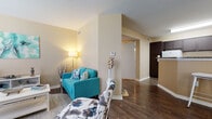 Located at 8787 Shenandoah Park Dr in Shenandoah, TX, this one-bedroom, one-bathroom single-floor residence offers a well-organized layout designed for comfortable everyday living. The living area is bright and inviting, featuring rich hardwood-style flooring, a large window that allows natural light to fill the room, and warm neutral wall tones that create a welcoming ambiance throughout. The open flow of the living space connects seamlessly to a dedicated dining area and the kitchen beyond. The galley-style kitchen is efficiently designed, featuring dark espresso cabinetry, granite-tone countertops, white appliances including a range and dishwasher, and a stainless steel sink — offering both functionality and a clean aesthetic contrast. The bedroom is generously sized, finished with plush carpet flooring, and includes a ceiling fan for year-round comfort. A sliding glass door leads directly to a private outdoor patio, bringing in natural light and outdoor access. The full bathroom is neatly appointed with dark cabinetry, a granite-tone vanity countertop, a mirrored medicine cabinet, and a tub-shower combination. Hardwood-style flooring continues into the bathroom, tying the home's design together cohesively. This unit offers a practical and comfortable living experience in a convenient Shenandoah location.