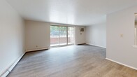 Located at 23462 Lorain Rd in North Olmsted, Ohio, this one-bedroom, one-bathroom unit is thoughtfully laid out across a single floor, making efficient use of its cozy footprint. The living room serves as the central gathering space, featuring light hardwood-style flooring, neutral walls, and a large sliding glass door that invites natural light and provides outdoor views. A baseboard heating system and wall-mounted air conditioning unit ensure year-round comfort. The kitchen is positioned adjacent to the living area, offering a functional workspace with cabinetry and counter space visible in the floor plan. The bedroom is a well-proportioned private retreat, finished with plush wall-to-wall carpeting and a multi-pane window that allows natural light to fill the room. A dedicated closet provides convenient storage. A second carpeted room with clean white walls and recessed ceiling-mounted light fixtures offers additional flexible living space. The full bathroom is finished with classic white subway tile surrounding a full-size soaking tub and shower combination, maintaining a clean and timeless aesthetic throughout. Overall, the unit presents a neutral, move-in-ready palette well-suited for comfortable everyday living.