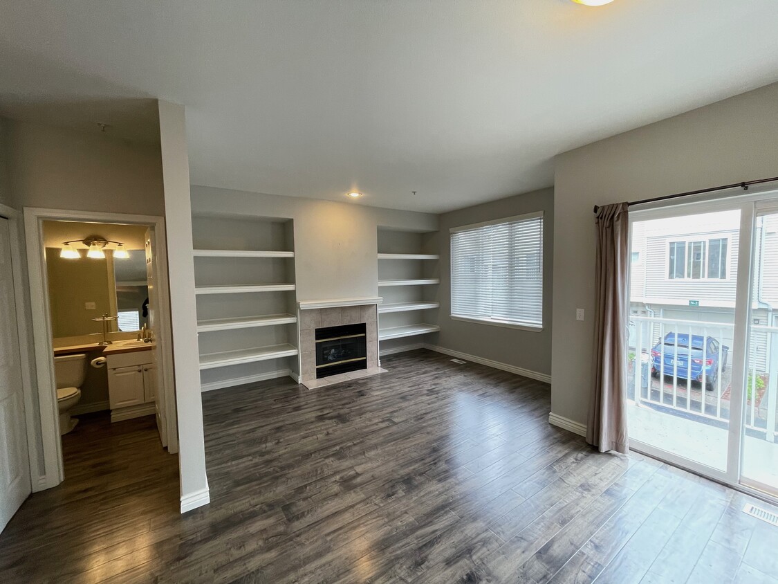 living room with gas fireplace and built-in shelving - 13400 Dumas Rd