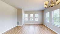 Located at 301 E Main St in Waunakee, WI, this well-appointed 2-bedroom, 2-bathroom single-floor residence offers a thoughtfully designed layout with modern finishes throughout. The open-concept kitchen and living area serves as the heart of the home, featuring white cabinetry, stainless steel appliances, a center island with a built-in sink, pendant lighting, and light hardwood-style flooring that flows seamlessly into the bright living and dining spaces. Multiple large windows throughout the living and dining areas flood the space with natural light while offering pleasant outdoor views. An elegant chandelier accents the dining area, enhancing the warm, welcoming ambiance. The primary bedroom is generously sized, fitted with soft carpeting and a window providing natural light, and is accompanied by a private en-suite bathroom complete with a white vanity, ample cabinetry, and a shower. A dedicated walk-in closet with built-in shelving and hanging rods provides excellent storage. The second bedroom is equally well-sized with carpeted flooring and a bright window. A second full bathroom includes a soaking tub and shower combination with hardwood-style flooring. The neutral, warm color palette and clean architectural lines give the entire residence a fresh, move-in-ready feel.