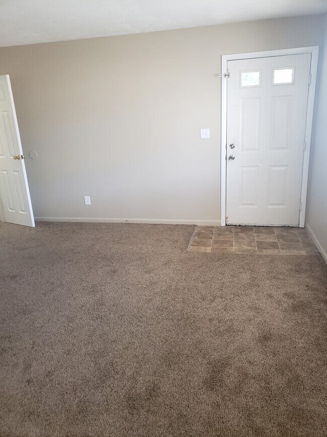 Living room with front door at right and closet door at right - 2322 Ontario St.