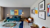 This thoughtfully designed single-floor residence offers a seamless blend of modern aesthetics and functional living across its well-proportioned rooms. The living area serves as the centerpiece of the home, featuring bold, curated décor with a striking teal velvet sofa, mid-century modern furnishings, and a vibrant triptych of colorful artwork anchoring the deep gray accent wall. A gallery wall adds additional visual interest, while layered lighting from arc and globe floor lamps creates a warm, inviting ambiance throughout the space.

The kitchen is efficiently laid out with warm honey-toned wood cabinetry, dark granite countertops, and black appliances including a gas range and refrigerator. Light hardwood flooring adds warmth and continuity, with easy access to additional storage via a closet just off the kitchen.

Both bedrooms are generously sized with plush carpeting, natural light from large windows dressed in sheer curtains, and carefully selected artwork. The primary bedroom features a bold teal-toned bedding ensemble, a textured sculptural wall panel triptych above the bed, and ample closet space with built-in shelving. The second bedroom mirrors a similarly cozy aesthetic with neutral tones and its own closet.

The full bathroom is clean and well-appointed, featuring a tub-shower combination with a striped curtain, wood vanity cabinetry, and warm wood-toned flooring, completing this cohesive and stylish home.
