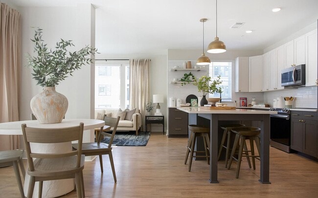 A kitchen island seats three and still leaves room to prep and plate up. - Sinclair Cary