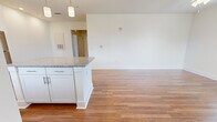 Located in Lebanon, Indiana, this well-appointed 1-bedroom, 1-bathroom single-floor unit offers a thoughtfully designed layout that maximizes both functionality and comfort. Warm hardwood-style flooring runs consistently throughout the space, lending a cohesive, polished look to every room.

The kitchen is a standout feature, showcasing crisp white cabinetry, a subway tile backsplash, granite countertops, and a full suite of stainless steel appliances including a refrigerator, range, microwave, and dishwasher. A peninsula with additional granite counter space provides a natural transition into the open living area, which is bathed in natural light from multiple windows offering views of the surrounding neighborhood.

The generously sized bedroom includes a ceiling fan and a large window that further enhances the sense of natural brightness. The bathroom is well-equipped with white cabinetry, granite countertops, and direct access to a dedicated closet with built-in shelving, offering practical storage solutions.

Throughout the unit, clean white walls, panel-style doors, and consistent trim details contribute to a fresh, modern aesthetic. The entrance and hallway connect all areas seamlessly, making the overall layout feel intuitive and efficient. This unit combines contemporary finishes with functional design in a compact, easy-to-navigate floor plan.