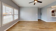 Located at 3385 Cedar Valley Way in Hamburg, NY, this well-appointed 2-bedroom, 1-bathroom home offers a thoughtfully designed single-floor layout with a clean, contemporary aesthetic throughout. Consistent light hardwood-style flooring flows across the living spaces, complemented by cool gray walls and crisp white trim that create a bright, cohesive atmosphere.

The combined kitchen and living room serves as the heart of the home. The kitchen is outfitted with rich dark gray shaker-style cabinetry, white countertops, and a full suite of stainless steel appliances including a gas range, over-the-range microwave, and refrigerator. Recessed lighting and ample cabinet storage make this a highly functional cooking space.

The spacious primary bedroom features natural light from a double window with blinds and a ceiling fan overhead. The second bedroom is equally well-sized and similarly finished, providing versatile use of space. Both rooms are served by two closets — including a walk-in closet equipped with wire shelving systems for organized storage.

The bathroom features a clean tub/shower combo with brushed nickel fixtures set against bright white surround walls. Two hallways connect the rooms efficiently. An attached garage with an automatic opener rounds out this practical and modern home.